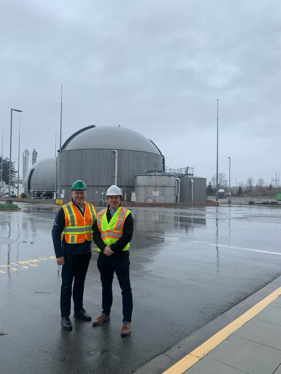 2 Staff members standing outside of a bio facility.