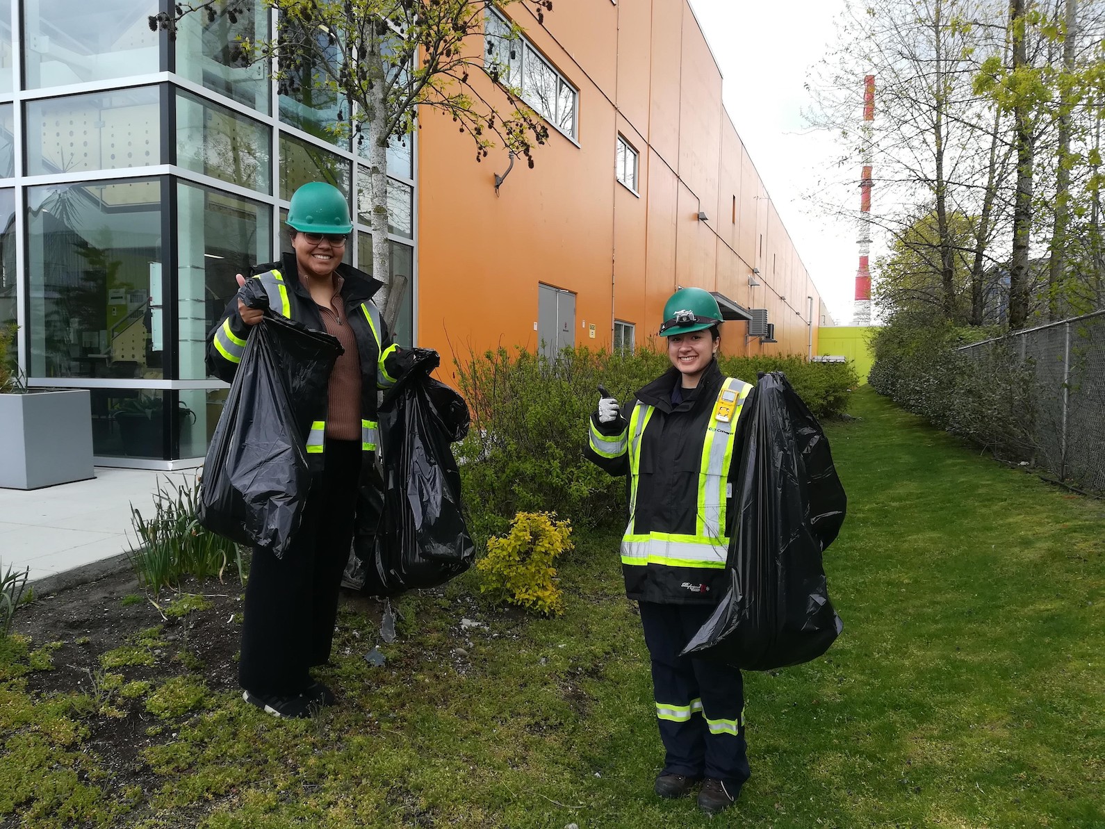 2 facials with black garbage bags performing cleanup